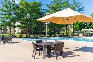 Table and umbrella next to an outdoor pool